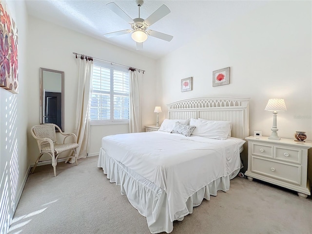 bedroom with ceiling fan and light carpet