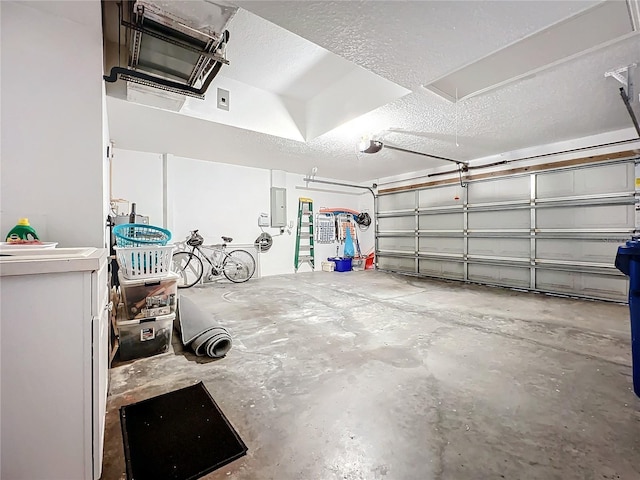 garage featuring electric panel and a garage door opener