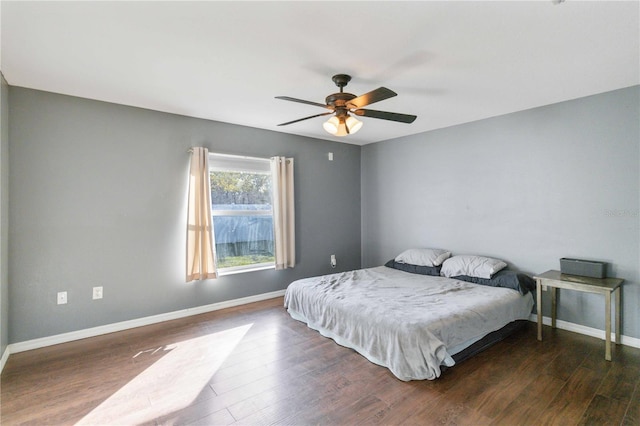 bedroom featuring dark hardwood / wood-style flooring and ceiling fan