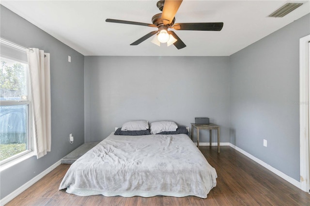 bedroom with ceiling fan and dark hardwood / wood-style flooring