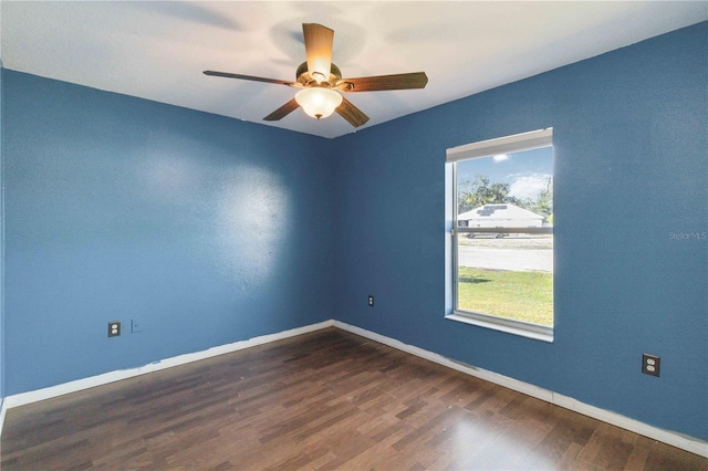 unfurnished room featuring dark hardwood / wood-style flooring and ceiling fan