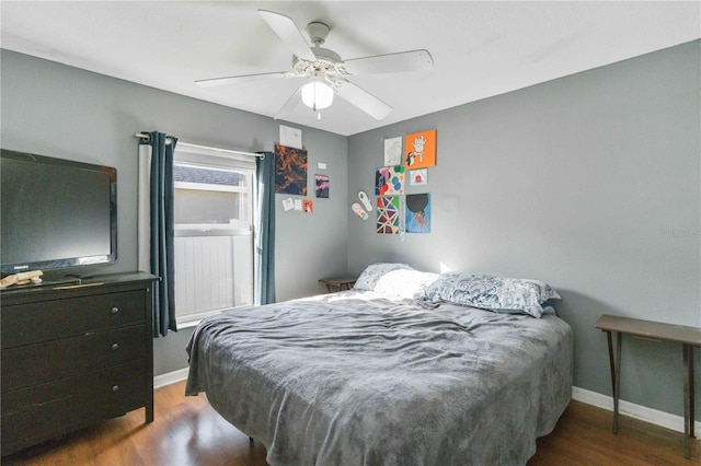 bedroom with ceiling fan and dark wood-type flooring