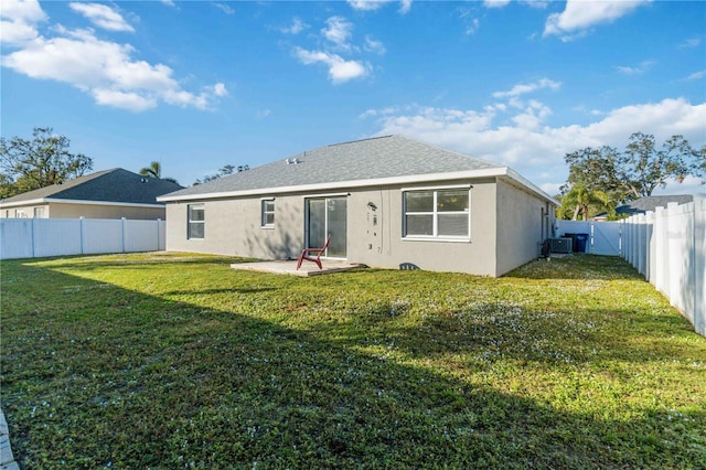 rear view of property with a yard and cooling unit