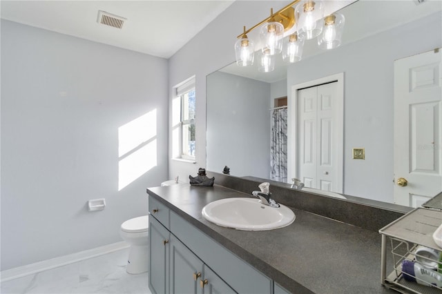 bathroom featuring vanity and toilet