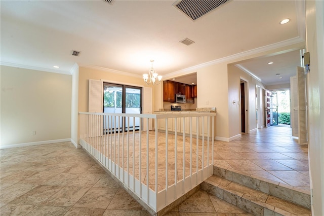 kitchen with kitchen peninsula, crown molding, a healthy amount of sunlight, and an inviting chandelier