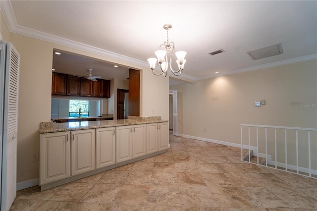 kitchen featuring pendant lighting, sink, light stone counters, and crown molding