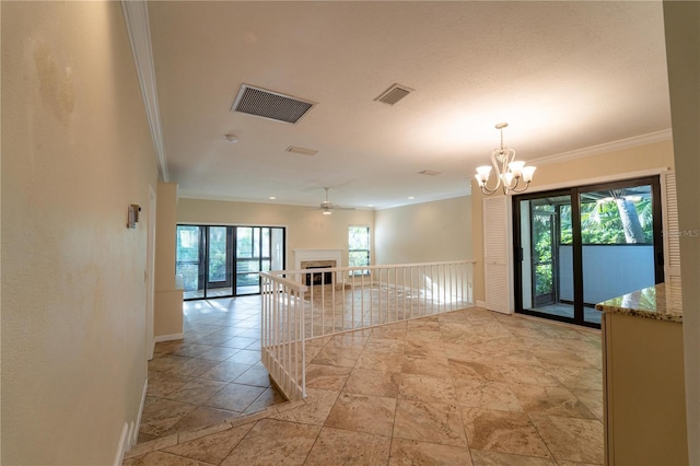 unfurnished room featuring ceiling fan with notable chandelier and ornamental molding