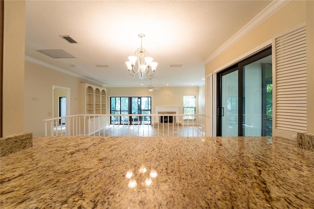 interior space with an inviting chandelier and crown molding