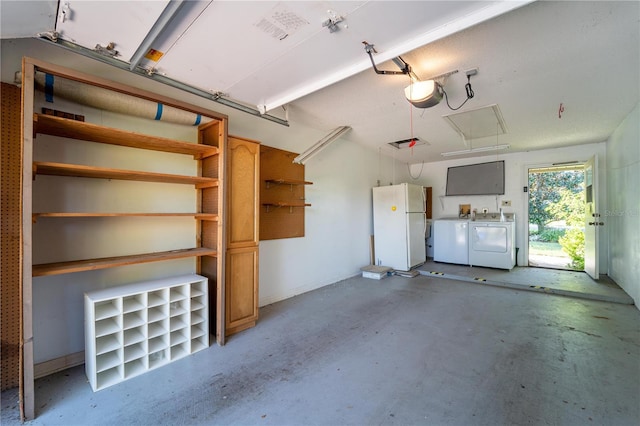 garage with washer and clothes dryer, white fridge, and a garage door opener