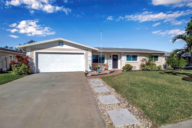 ranch-style house featuring a garage and a front lawn