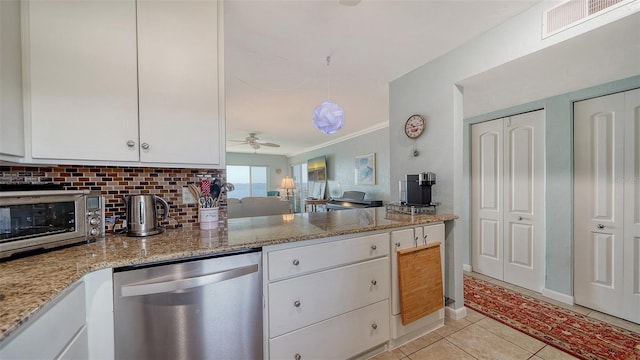 kitchen featuring white cabinets, light stone counters, ceiling fan, light tile patterned floors, and dishwasher