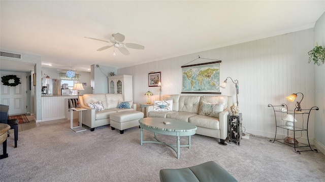 carpeted living room with ceiling fan