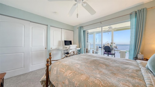 carpeted bedroom with two closets and ceiling fan