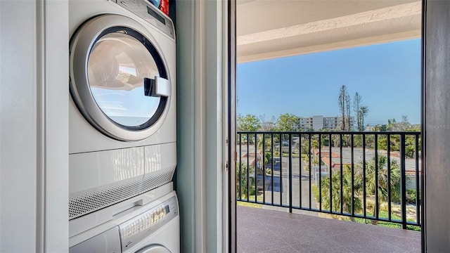 laundry room with stacked washing maching and dryer