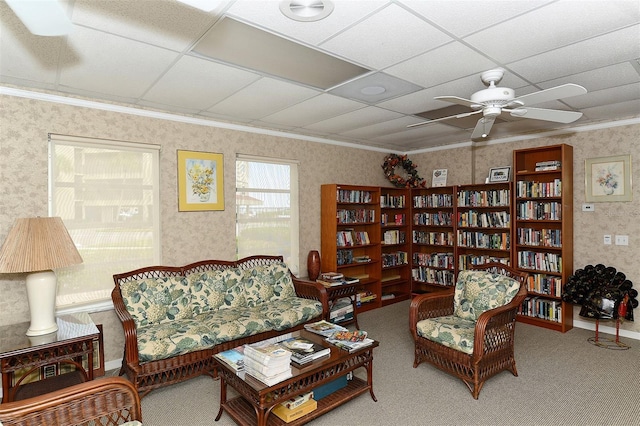 living room featuring a paneled ceiling, crown molding, carpet floors, and ceiling fan