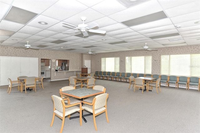 dining space featuring a drop ceiling and a healthy amount of sunlight