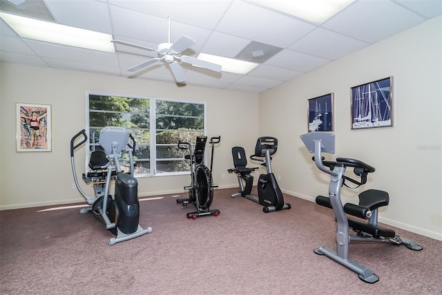 exercise room featuring a paneled ceiling and ceiling fan