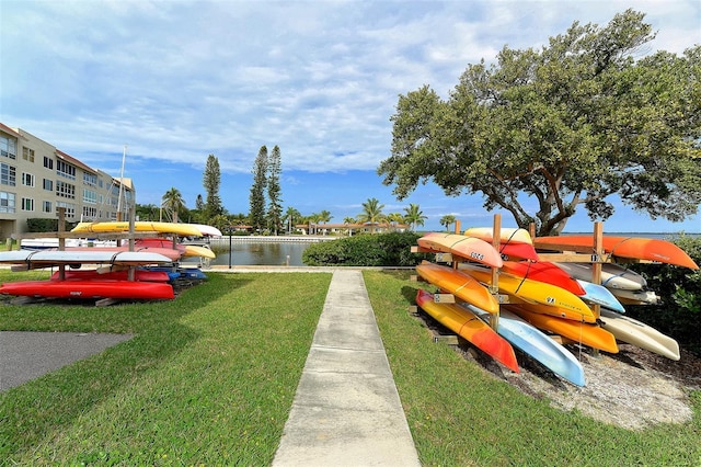 exterior space featuring a water view and a lawn