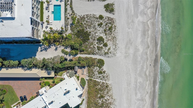 drone / aerial view featuring a water view and a beach view