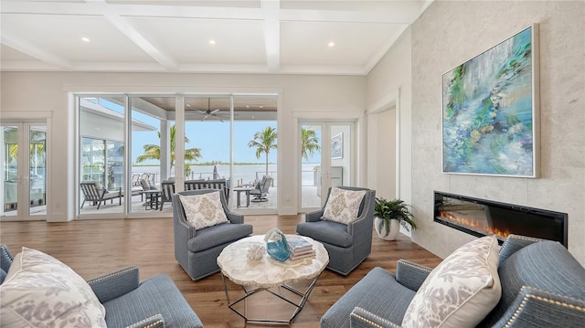 sunroom with beamed ceiling, coffered ceiling, a fireplace, and french doors