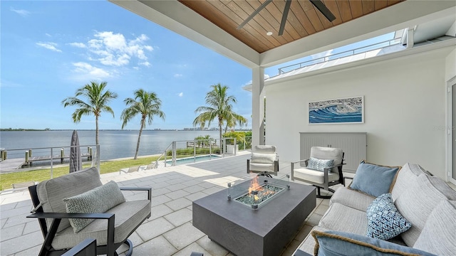 view of patio / terrace with a water view and a fire pit