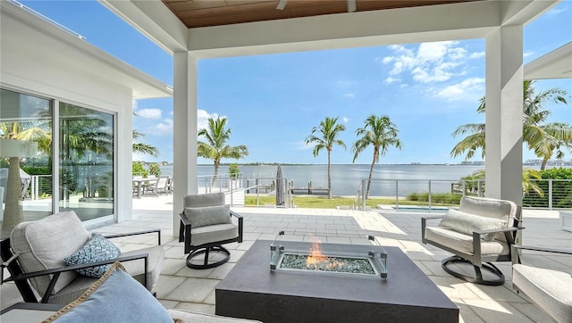 view of patio featuring a fire pit and a water view