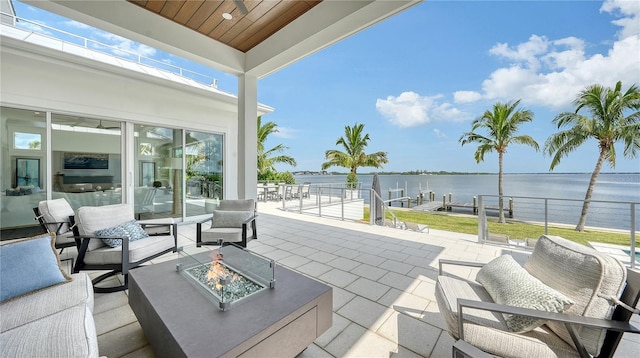 view of patio featuring a water view and an outdoor fire pit