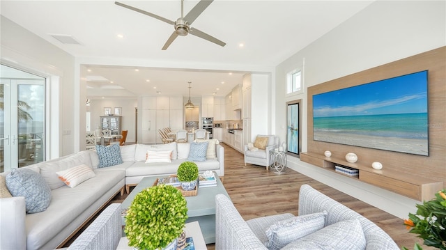 living room featuring hardwood / wood-style floors and ceiling fan