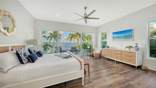 bedroom featuring access to outside, multiple windows, ceiling fan, and hardwood / wood-style floors