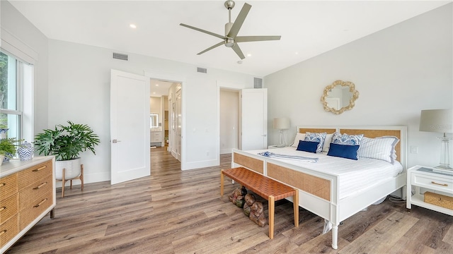 bedroom with ceiling fan and hardwood / wood-style flooring