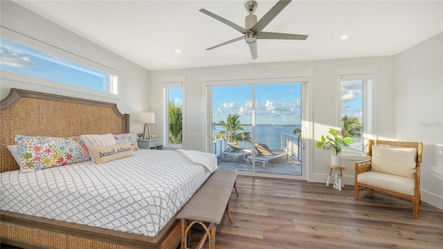 bedroom featuring access to outside, multiple windows, ceiling fan, and hardwood / wood-style flooring