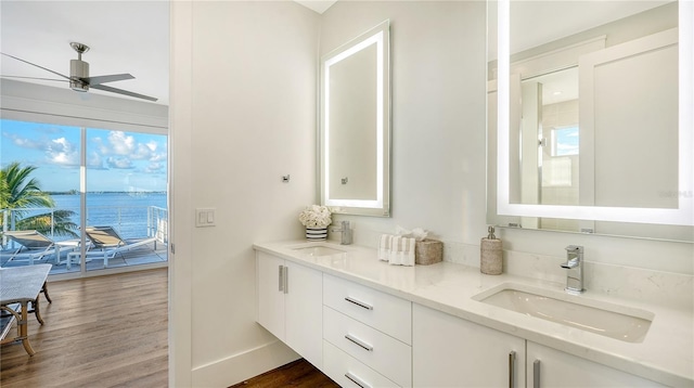 bathroom featuring vanity, ceiling fan, hardwood / wood-style floors, and a water view