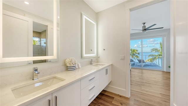 bathroom with hardwood / wood-style floors, vanity, and ceiling fan