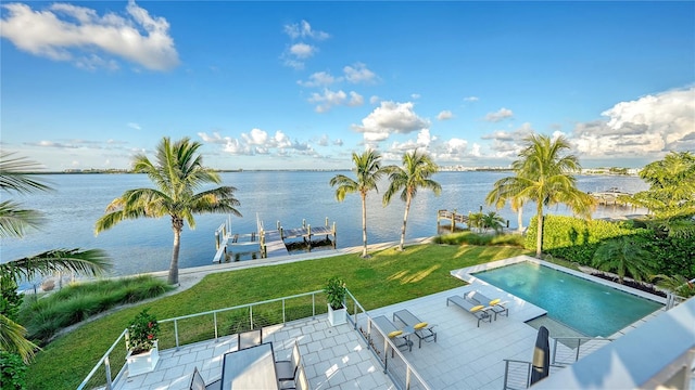 view of pool with a lawn, a boat dock, a water view, and a patio