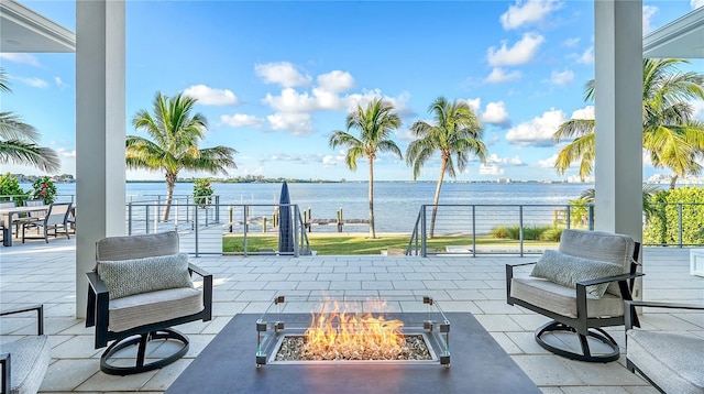 view of patio / terrace featuring a fire pit and a water view