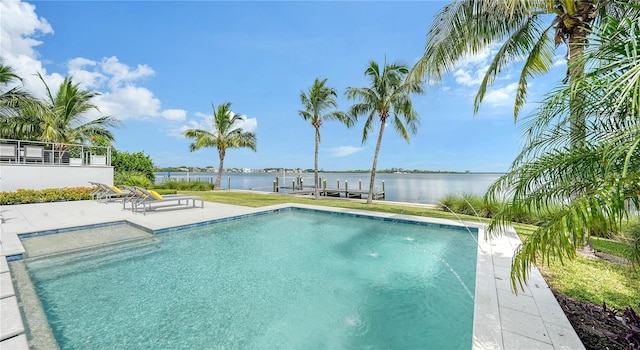 view of pool with a boat dock, a water view, and a patio area