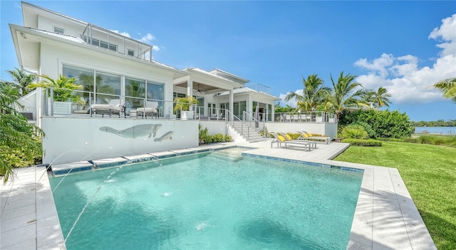 rear view of property with pool water feature, ceiling fan, a patio area, and a yard