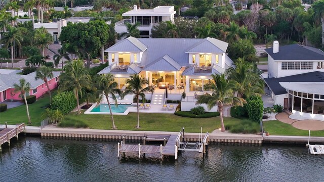 back of house featuring a balcony and a water view