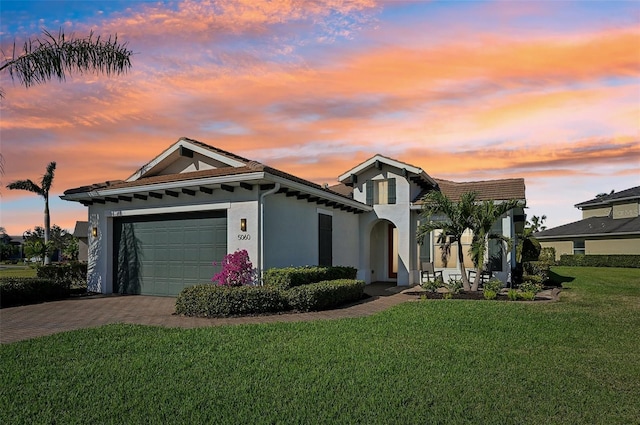 view of front of property featuring a garage and a yard