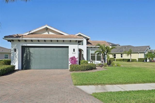 view of front of house featuring a front yard and a garage