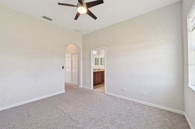 carpeted empty room featuring ceiling fan