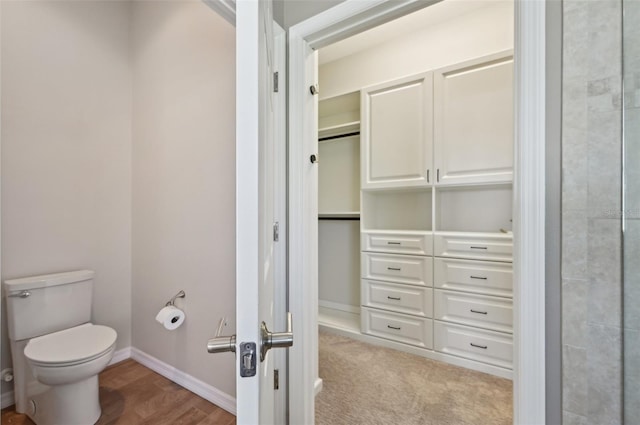 bathroom with wood-type flooring and toilet