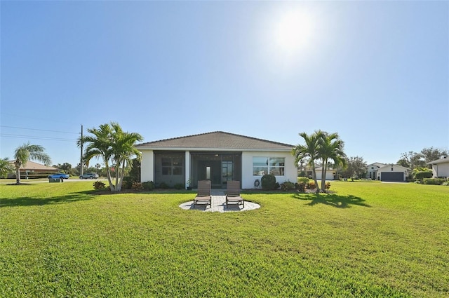 rear view of house featuring a yard