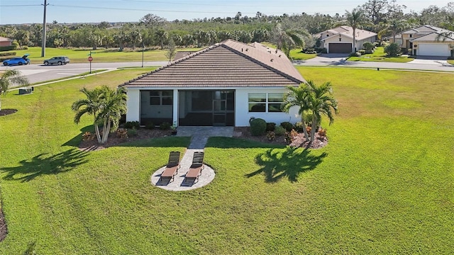 back of house with a lawn