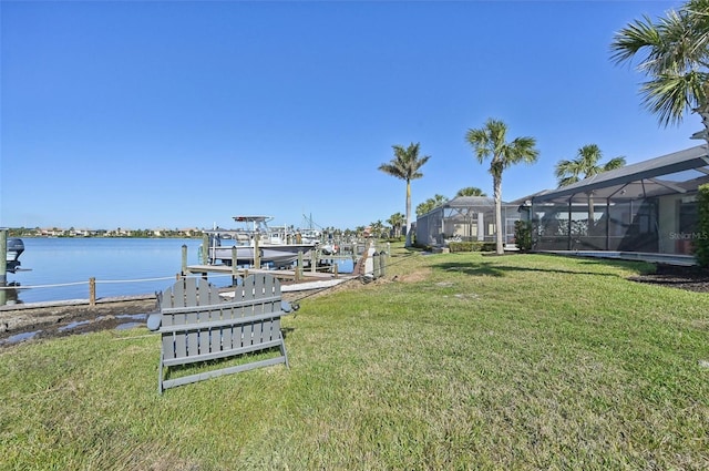 view of dock featuring a water view, glass enclosure, and a lawn