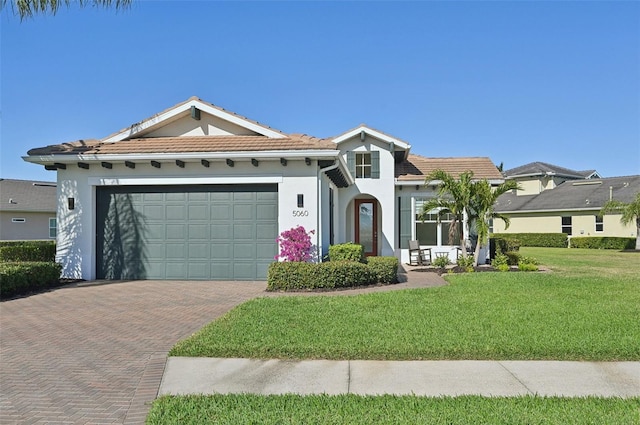 view of front of house featuring a garage and a front lawn