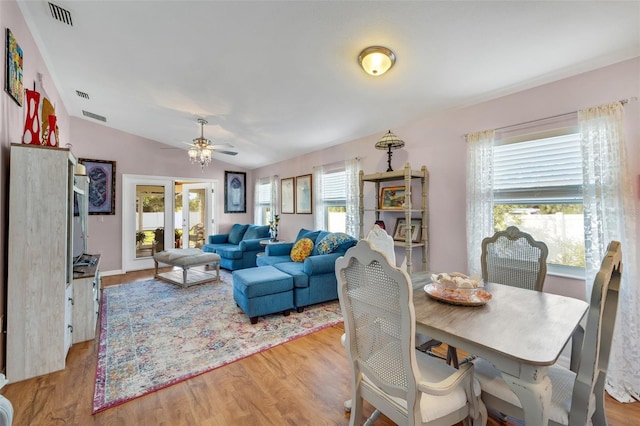 dining area with ceiling fan, french doors, light hardwood / wood-style flooring, and vaulted ceiling