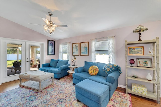 living room with ceiling fan, a healthy amount of sunlight, and lofted ceiling