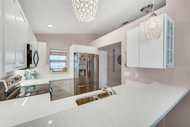 kitchen featuring kitchen peninsula, white cabinetry, sink, and appliances with stainless steel finishes