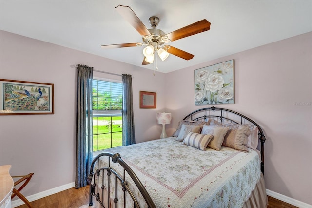 bedroom featuring hardwood / wood-style floors and ceiling fan